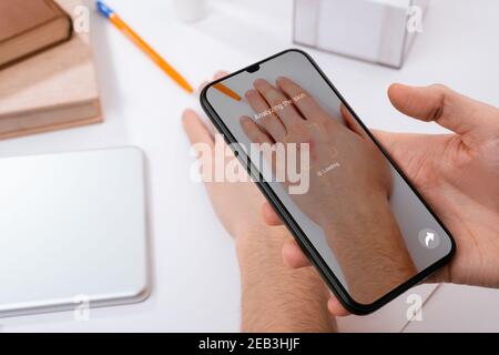 Man using a phone app to recognize skin problems on his hand Stock Photo