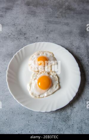 From Above Of Sunny Side Up Egg With Fried Bacon Slices And Condiments 