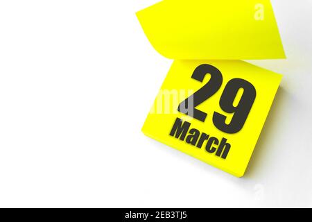 March 29th. Day 29 of month, Calendar date. Close-Up Blank Yellow paper reminder sticky note on White Background. Spring month, day of the year concep Stock Photo