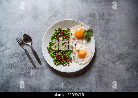 Beans and egg poaches are a popular breakfast ingredient. Top view, selective focus. Stock Photo