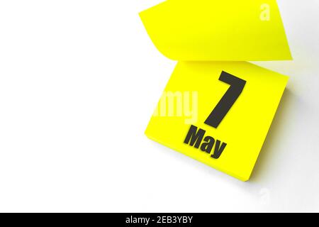 May 7th. Day 7 of month, Calendar date. Close-Up Blank Yellow paper reminder sticky note on White Background. Spring month, day of the year concept Stock Photo