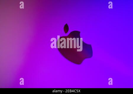 Apple logo, in neon purple backlight, dark lightingApple logo, in neon purple backlight, dark lighting Stock Photo