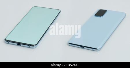 Smartphone lay on white surface back and forward view isolated Stock Photo
