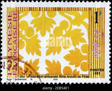 Graceful polynesian fabric on postage stamp Stock Photo