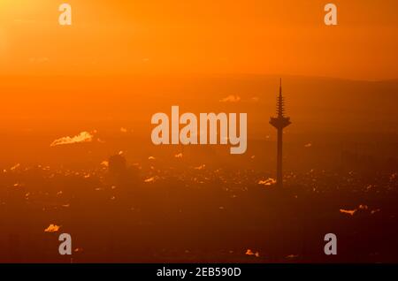 Hessen, Königstein-Falkenstein, 12 Feb 2021: Frankfurt's districts and the television tower, popularly known as Ginnheimer Spargel, are bathed in reddish-orange light at sunrise in the early morning. Photo: Arne Dedert/dpa Credit: dpa picture alliance/Alamy Live News Stock Photo
