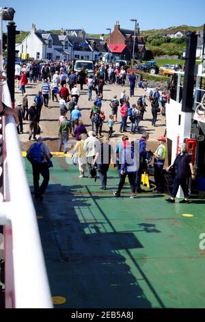 passengers disembarking at Iona from the Mull to Iona ferry in the Inner Hebrides of Scotland Stock Photo