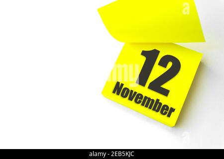 November 12nd. Day 12 of month, Calendar date. White alarm clock on yellow  background with calendar day. Autumn month, day of the year concept. Stock  Photo