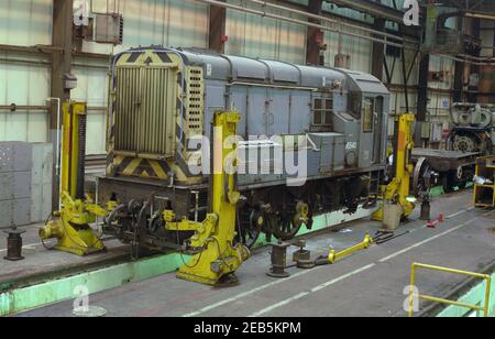 British Rail class 08 diesel shunting locomotives in the engine shed undergoing maintenance. Stock Photo