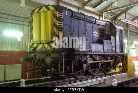 British Rail class 08 diesel shunting locomotives in the engine shed undergoing maintenance. Stock Photo