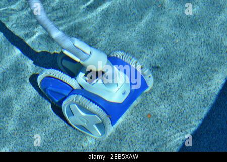 A swimming pool cleaning system at work. Stock Photo