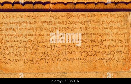 Inscriptions of tamil text on the walls of historical Brihadeeswar temple in Thanjavur, Tamilnadu. Ancient tamil inscriptions carved in the walls. Stock Photo