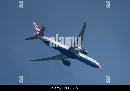London, UK. 12 February 2021. Air traffic over London during the Covid-19 pandemic. A British Airways Boeing 777 flies over Wimbledon after leaving London Heathrow en route to Mumbai. Credit: Malcolm Park/Alamy. Stock Photo