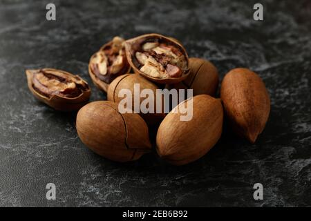 Tasty pecan nuts on black smokey background Stock Photo