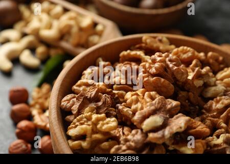 Wooden bowl with walnuts, close up and space for text Stock Photo