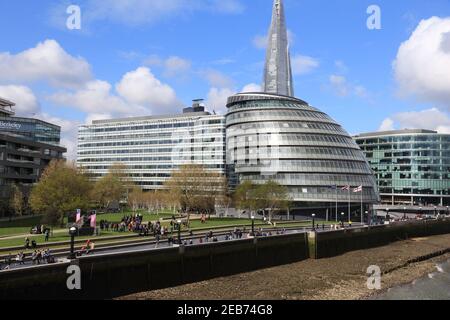 LONDON, UK - APRIL 23, 2016: People walk next to the City Hall (GLA) in London. London is the most populous city and metropolitan area of the European Stock Photo
