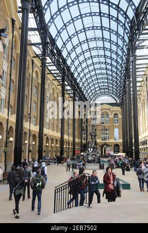 LONDON, UK - APRIL 23, 2016: People visit Hay's Galleria in London, UK. Originally a warehouse known as Hay's Wharf, it was redeveloped as mixed use r Stock Photo