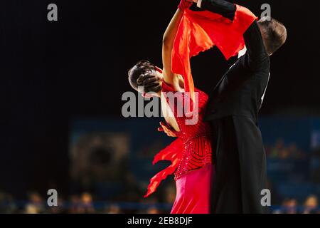 dancers man in black tailcoat and woman in red ball gown Stock Photo