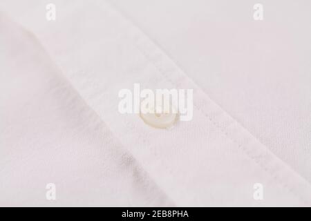 a button on a white men's shirt close up Stock Photo