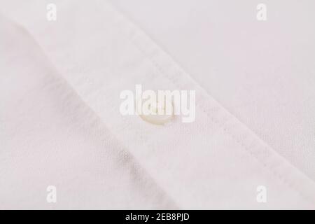 a button on a white men's shirt close up Stock Photo