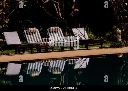 Sun loungers are lined up in front of the pool, Cambodia, Asia. Stock Photo