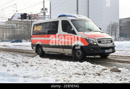 Leipzig, Germany. 10th Feb, 2021. An ASB (Arbeiter Samariter Bund) 'ambulance' makes its way along a street cleared of snow in Leipzig. Credit: Volkmar Heinz/dpa-Zentralbild/ZB/dpa/Alamy Live News Stock Photo