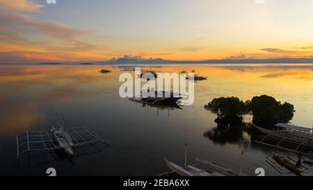 Dramatic sunset over the Islands and the sea. Philippines. Sunset in the tropics. Stock Photo