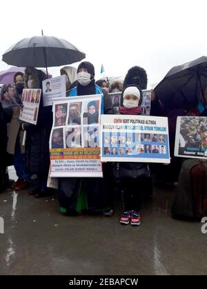 Istanbul, Turkey. 12th Feb, 2021. Members of the Uighur community living in Turkey hold up pictures of missing family members and chant 'China Stop Genocide' near the Chinese consulate. In Istanbul, some 200 Uyghurs have protested, calling on the Chinese leadership to provide them with information about suspected missing family members. Credit: Ergin Hava/dpa/Alamy Live News Stock Photo