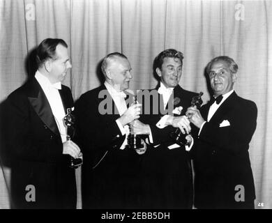 KIRK DOUGLAS presents the Best Writing, Story and Screenplay Academy Award / Oscar to RICHARD BREEN CHARLES BRACKETT and WALTER REISCH for TITANIC 1953 on March 25th 1954 at the RKO Pantages Theatre in Hollywood publicity for Twentieth Century Fox Stock Photo