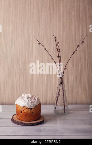 Easter cakes decorated with marshmallows on a light wooen background with willow. Stock Photo