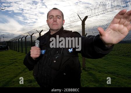 UK Police Officer using Incapacitant Spray Stock Photo