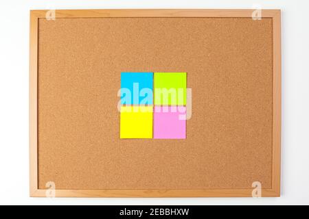 Cork board with several colorful blank notes with pins Stock Photo