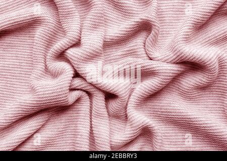 Pink woolen knitted fabric as background Stock Photo