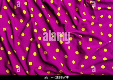 Polka dot purple and yellow fabric background Stock Photo