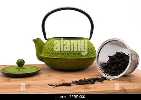 green teapot on wooden board Stock Photo