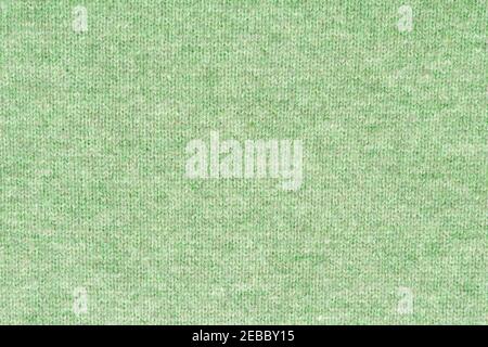 Melange green woolen knitted fabric as background Stock Photo