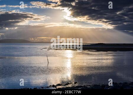 Early Evening with setting suns and Crepuscular rays Stock Photo