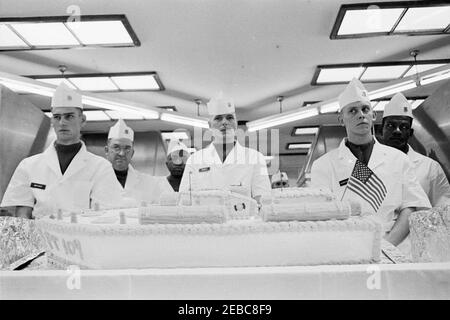 Trip to Europe: Germany, Hanau: President Kennedy has lunch with U.S. enlisted troops and their officers at Fliegerhorst Kaserne, 12:15PM. Military personnel stand with a cake in the shape of PT-109 in the mess hall at Fliegerhorst Kaserne to commemorate President John F. Kennedyu2019s visit to Hanau, West Germany (Federal Republic). Stock Photo