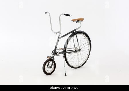 Velocino bicycle with small front wheel, big back wheel on white background. Stock Photo