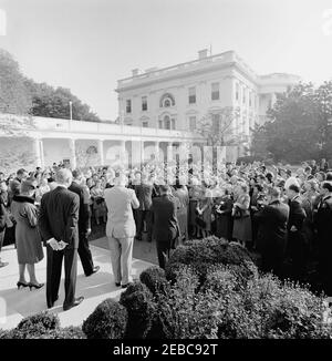 Visit of members of the New York Savings Banks Association, 9:20AM. President John F. Kennedy (center left, with back to camera) greets members of the Savings Banks Association of New York State and their wives, following the groupu0027s tour of the White House. President of the Association, Alfred S. Mills (third from left), stands on the steps in the foreground; others are unidentified. Washington Correspondent for the Guy Gannett Publishing Company of Maine, May Craig (very back, second from right), stands in the background. Rose Garden, White House, Washington, D.C. Stock Photo