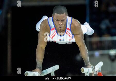 Toronto Panam Games 2015: Manrique Larduet from Cuba works in the parallel bars in Gymnastic Artistic. He ends in second place and gets the Silver Med Stock Photo