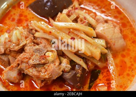 spicy boiled slice fresh bamboo shoot with chicken and blood in coconut milk curry soup on bowl Stock Photo