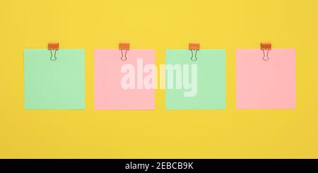 Four blank stickers, planning concept. Empty place for text, copy space. Colorful note paper with pins. Mockup, yellow bulletin board. Notice template Stock Photo