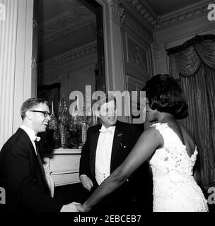 Dinner in honor of Vice President Lyndon B. Johnson (LBJ), Speaker of the House John W. McCormack, u0026 Chief Justice Earl Warren, 8:00PM. President John F. Kennedy (center) talks with mezzo-soprano opera singer Grace Bumbry and piano accompanist Charles Wadsworth (left) following Ms. Bumbryu0027s performance at a dinner in honor of Vice President Lyndon B. Johnson, Speaker of the House of Representatives John W. McCormack, and Supreme Court Chief Justice Earl Warren. East Room, White House, Washington, D.C. Stock Photo