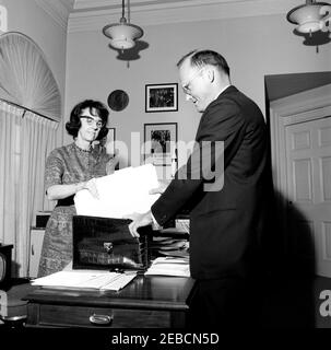 White House Staff: Military Aide to the President Gen. Chester V. Clifton, National Security Advisor McGeorge Bundy, Presidential Secretary Evelyn Lincoln. Personal Secretary to President John F. Kennedy Evelyn Lincoln (left) and Special Assistant to the President for National Security Affairs McGeorge Bundy place file folders into President Kennedyu0027s black alligator briefcase. Presidentu2019s Secretaryu2019s Office, White House, Washington, D.C. Stock Photo