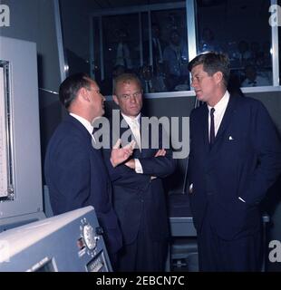 Presentation of the NASA (National Aeronautics and Space Administration) Distinguished Service Medal (DSM) to Astronaut John Herschel Glenn, Jr., at Cape Canaveral. Project Mercury Flight Director Christopher C. Kraft, Jr. (left) and astronaut Lieutenant Colonel John H. Glenn, Jr. (center) brief President John F. Kennedy on the operation of the Mercury Control Center at Cape Canaveral Air Force Station, prior to the presentation ceremony of the National Aeronautics and Space Administration (NASA) Distinguished Service Medal to Lieutenant Colonel Glenn. Brevard County, Florida. Stock Photo