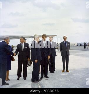 Trip to Bermuda: arrival at Kindley Air Force Base, Bermuda, 12:55PM. President John F. Kennedy speaks with Prime Minister of Great Britain Harold Macmillan upon the Presidentu2019s arrival in Bermuda from Palm Beach, Florida. L-R: US Secretary of State Dean Rusk; Lady Joyce Gascoigne (wife of the Governor of Bermuda, Major General Sir Julian Gascoigne), partially hidden; unidentified; Prime Minister Macmillan; President Kennedy; British Minister for Foreign Affairs and Earl of Home Alec Douglas-Home; British Ambassador to the United States Sir David Ormsby-Gore. Kindley Air Force Base, St. D Stock Photo
