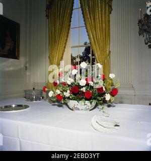 White House Rooms, Christmas decorations: East Room, Red Room, Green Room, Blue Room, State Dining Room, Cross Hall. Christmas decorations in the East Room; an arrangement of flowers sits on the table. White House, Washington, D.C. Stock Photo