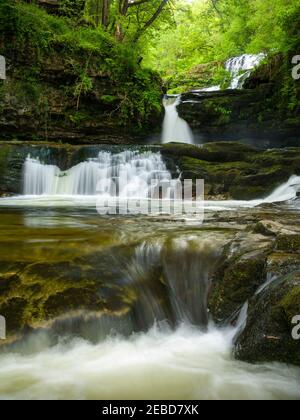 Sgwd Isaf Clun-gwyn (Lower Fall of the White Meadow) waterfall on the Afon Mellte river in the Bannau Brycheiniog (Brecon Beacons) National Park near Ystradfellte, Powys, Wales. Stock Photo