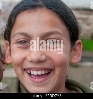 5-16-2018. Lomnicka, Slovakia. A close-up of Roma or Gypsy smiling girl in an abandoned community in the heart of Slovakia, living in miserable condit Stock Photo