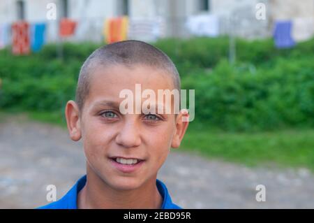 5-16-2018. Lomnicka, Slovakia. A close-up of a Roma or Gypsy boy in an abandoned community in the heart of Slovakia, living in miserable conditions. Stock Photo